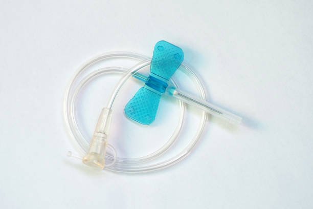 Blue butterfly catheter on light background. Butterfly dropper needle